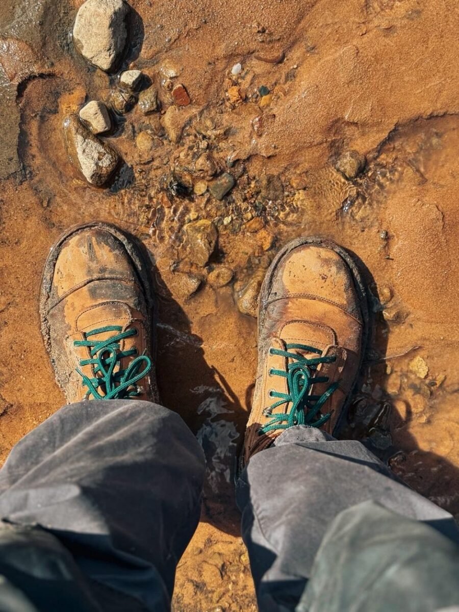Pietermaritzburg boot factory with stacks of leather rolls and workers on the floor